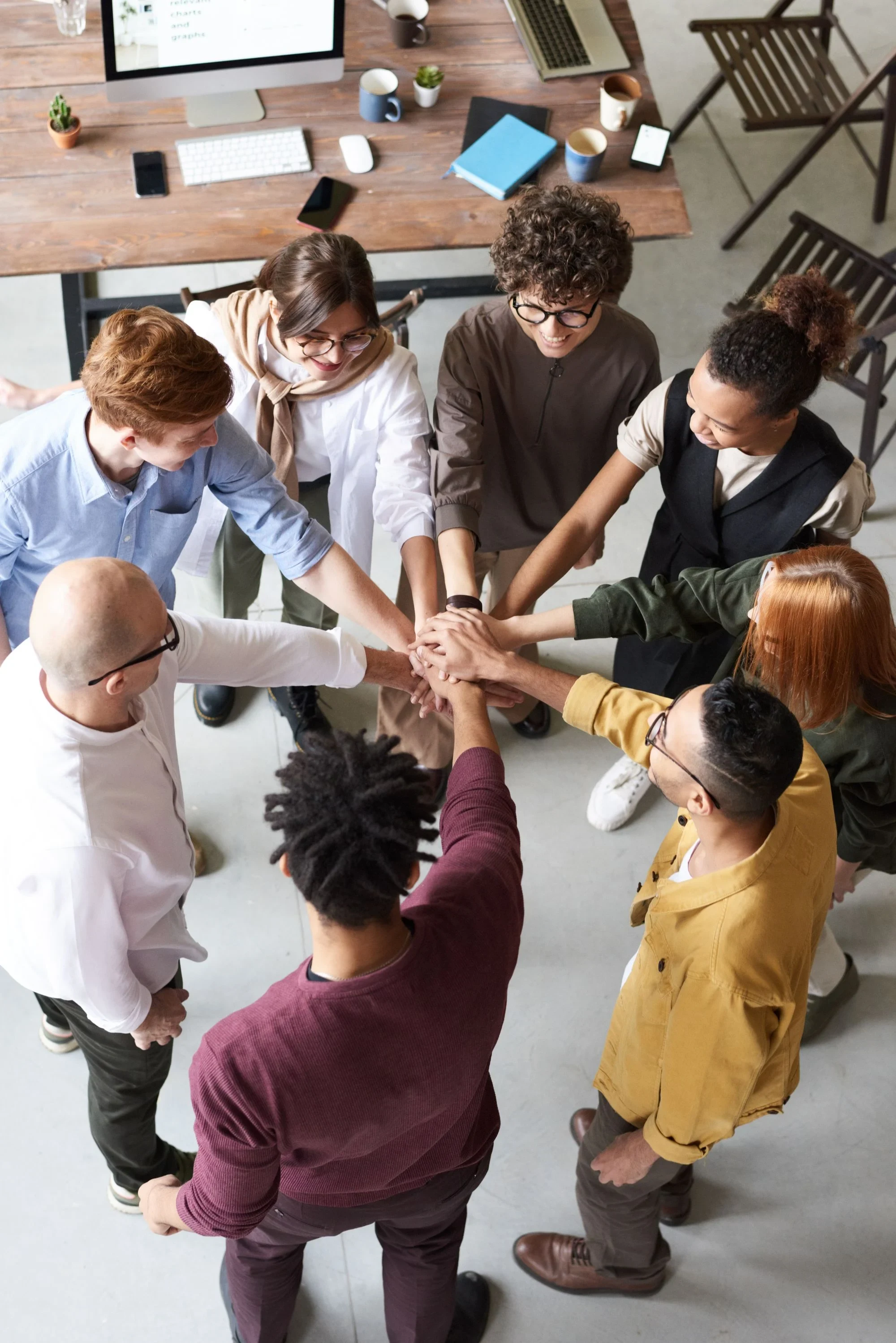 A small operations team reviewing work together around a table
